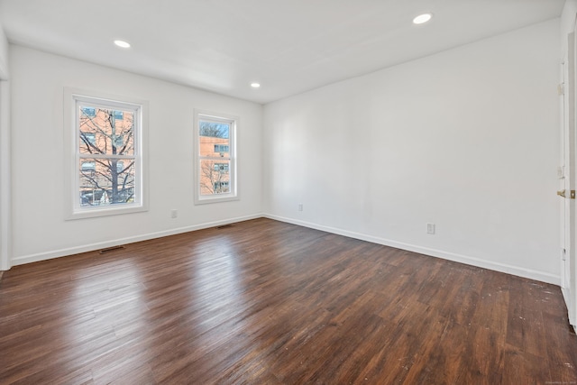 spare room with dark hardwood / wood-style floors