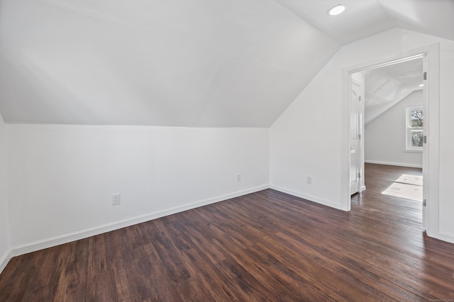 additional living space with lofted ceiling and dark wood-type flooring