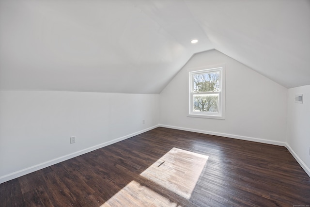 bonus room with lofted ceiling and dark hardwood / wood-style floors