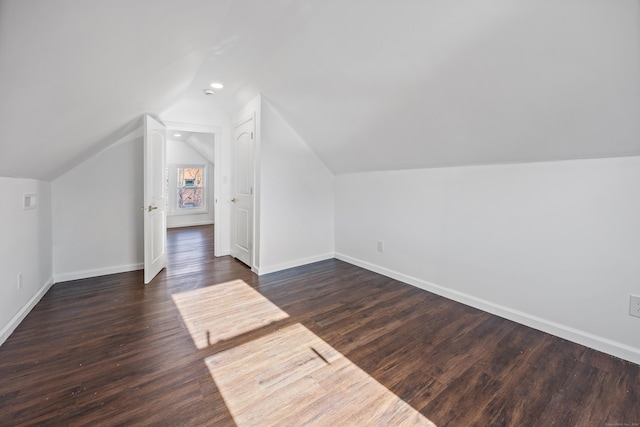 bonus room with dark hardwood / wood-style flooring and lofted ceiling