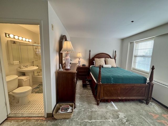 bedroom featuring ensuite bathroom and radiator