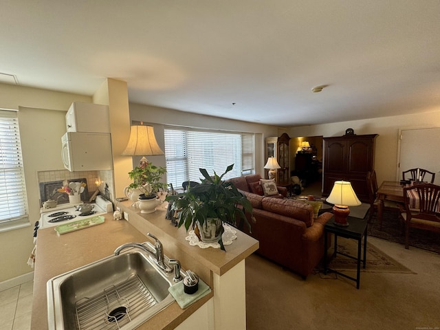 kitchen featuring kitchen peninsula, sink, and a healthy amount of sunlight