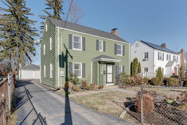 view of front of property with a garage and an outdoor structure