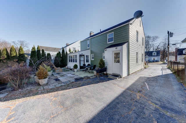 back of property with a patio