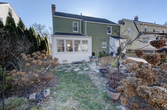 rear view of house featuring a yard