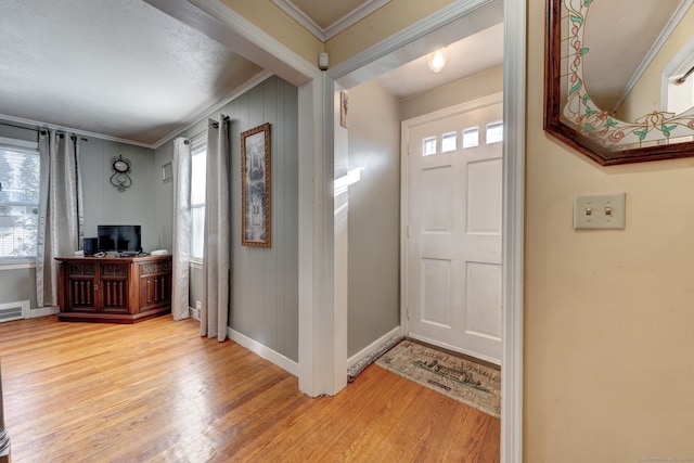 entryway with crown molding and wood-type flooring