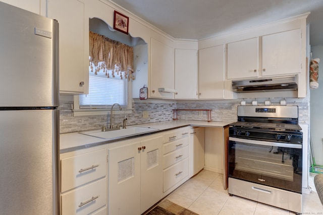 kitchen with white cabinetry, sink, tasteful backsplash, light tile patterned floors, and appliances with stainless steel finishes