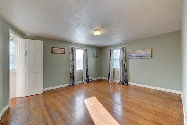 foyer featuring a textured ceiling and light hardwood / wood-style flooring