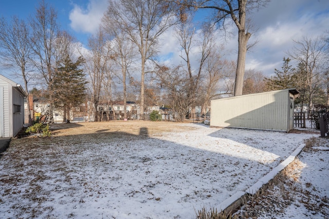 yard layered in snow featuring an outbuilding