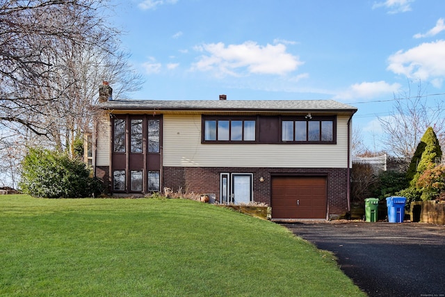 view of front of property with a garage and a front yard