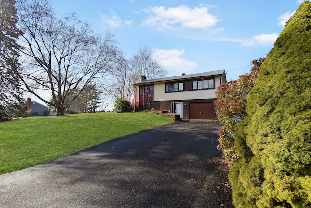 view of front of property with a front yard and a garage