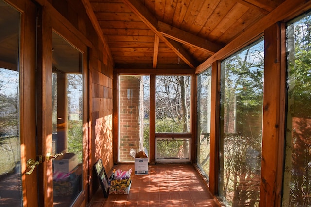 unfurnished sunroom featuring vaulted ceiling with beams, a water view, and wood ceiling