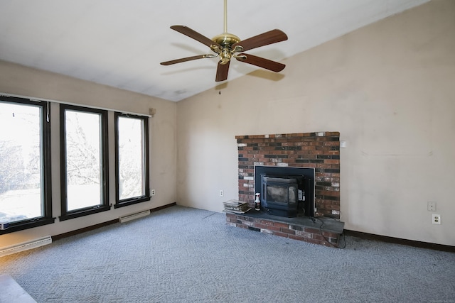 unfurnished living room with ceiling fan, lofted ceiling, carpet floors, and a wood stove