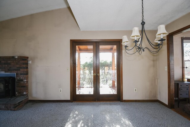 interior space featuring plenty of natural light, lofted ceiling, a textured ceiling, and french doors