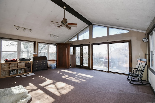 sunroom / solarium featuring french doors, lofted ceiling with beams, ceiling fan, and a healthy amount of sunlight