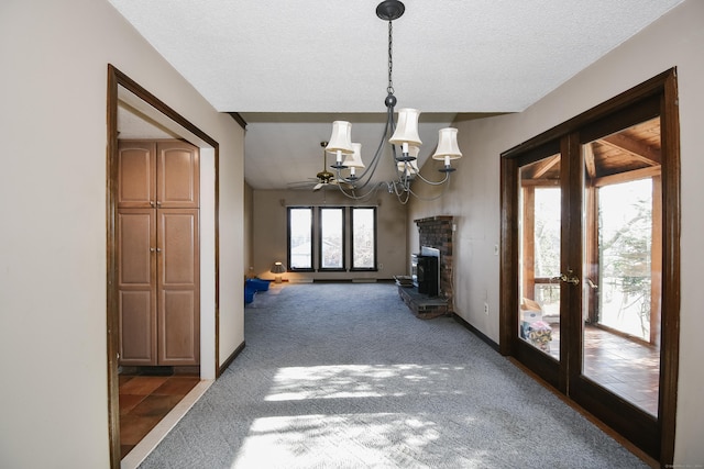 unfurnished living room featuring dark colored carpet, french doors, and a wealth of natural light