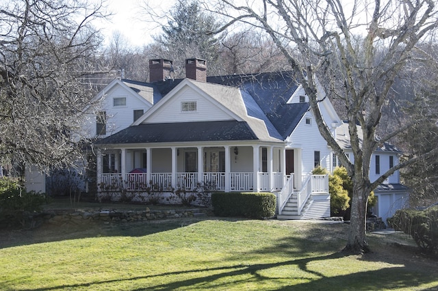 view of front of property with covered porch and a front yard