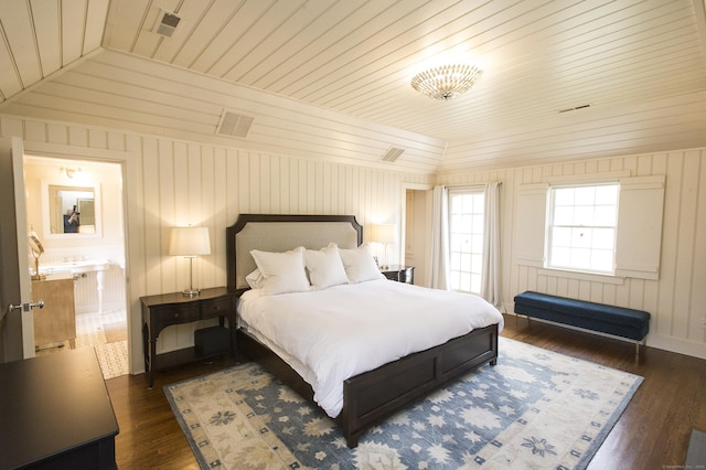 bedroom with dark hardwood / wood-style flooring, vaulted ceiling, wooden walls, and wood ceiling