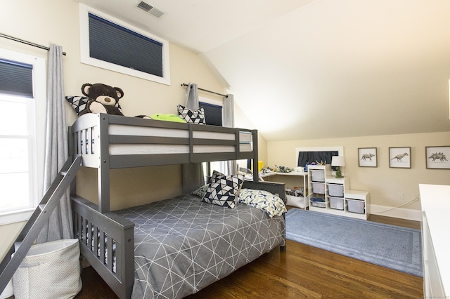 bedroom featuring dark hardwood / wood-style flooring and vaulted ceiling