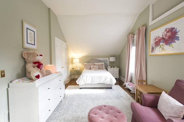 bedroom featuring light hardwood / wood-style floors and vaulted ceiling