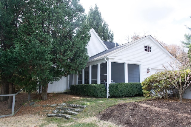 view of property exterior featuring a sunroom