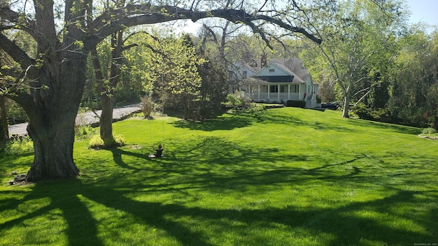 view of yard featuring covered porch