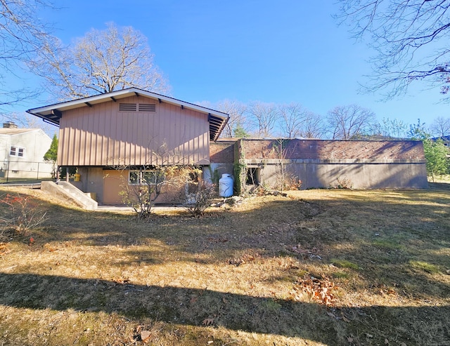 rear view of house with a lawn