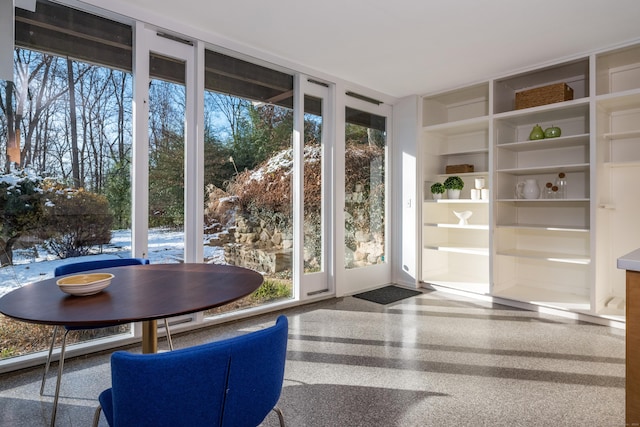 doorway to outside with plenty of natural light and built in features