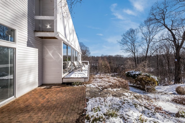 yard layered in snow featuring a patio area