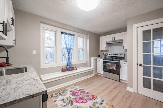 kitchen featuring white cabinetry, sink, light hardwood / wood-style floors, and stainless steel range with electric stovetop