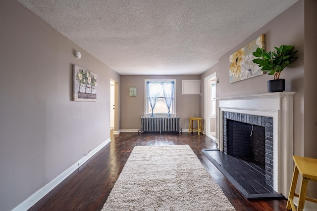 unfurnished living room featuring a textured ceiling, radiator, and dark hardwood / wood-style floors