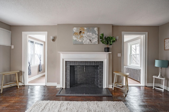 living room featuring dark hardwood / wood-style floors and a textured ceiling