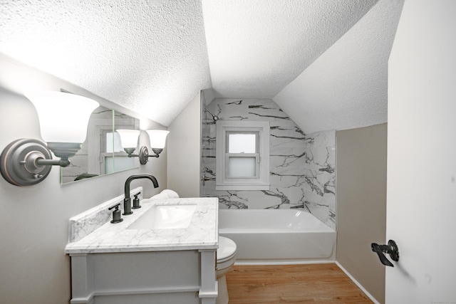 full bathroom with a textured ceiling, hardwood / wood-style floors, vanity, and vaulted ceiling