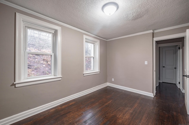 spare room with dark hardwood / wood-style floors, a healthy amount of sunlight, and a textured ceiling