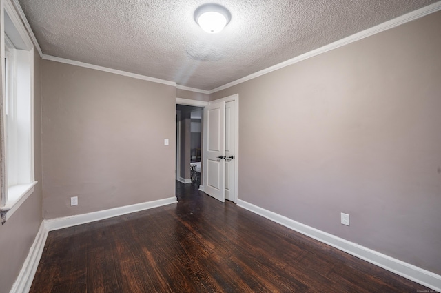 unfurnished room featuring dark hardwood / wood-style floors, crown molding, and a textured ceiling