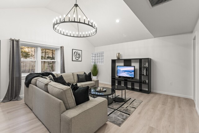 living room with high vaulted ceiling and light hardwood / wood-style flooring