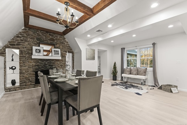 dining room featuring beam ceiling, an inviting chandelier, and light wood-type flooring