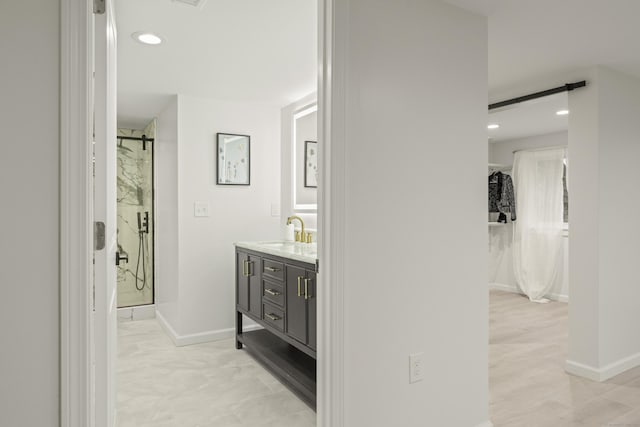 bathroom featuring vanity and tiled shower