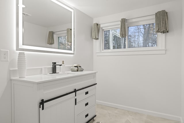 bathroom with vanity and plenty of natural light