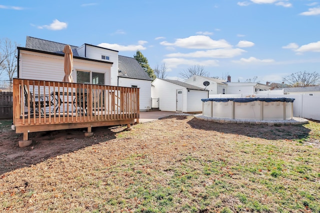 back of property featuring a swimming pool side deck