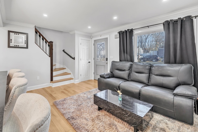 living room featuring ornamental molding and light hardwood / wood-style flooring