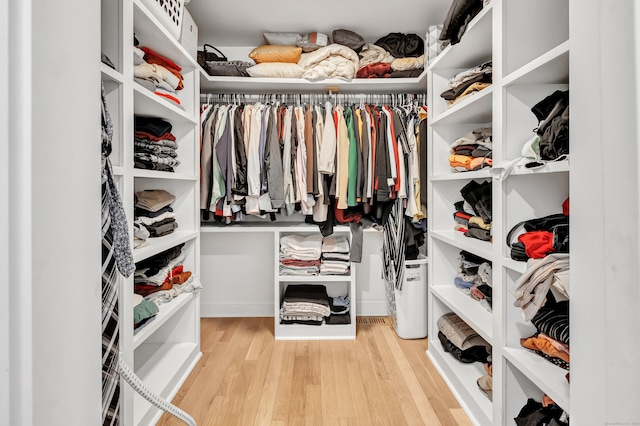 walk in closet featuring light hardwood / wood-style flooring