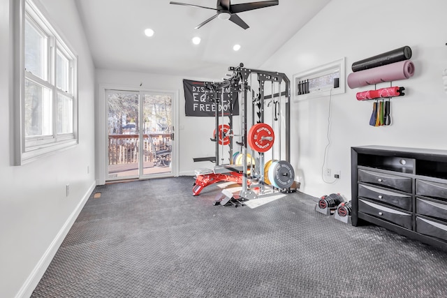 workout room with dark colored carpet, ceiling fan, and lofted ceiling