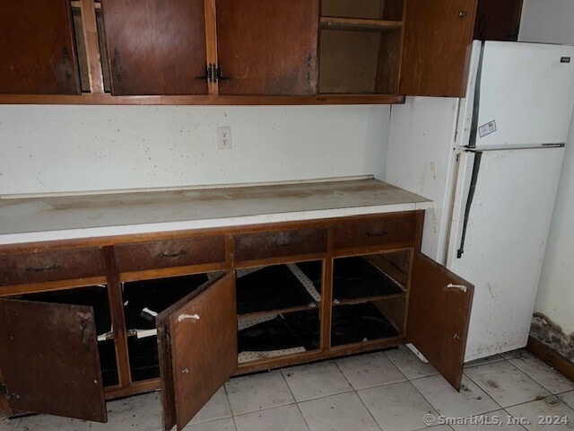 kitchen featuring white refrigerator and light tile patterned floors