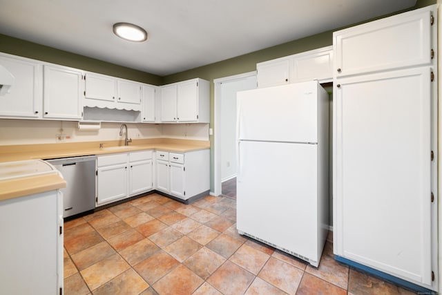 kitchen with dishwasher, white fridge, white cabinetry, and sink