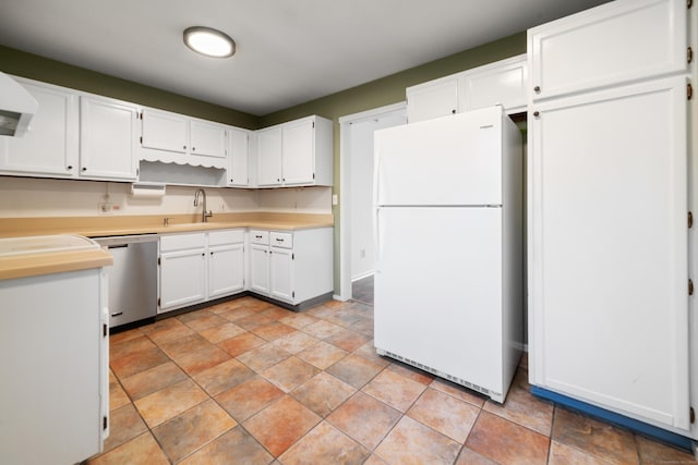 kitchen with sink, light tile patterned floors, white refrigerator, dishwasher, and white cabinetry