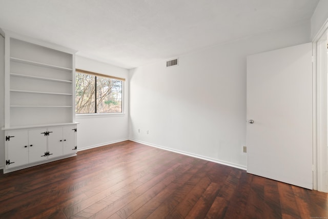 spare room featuring dark hardwood / wood-style flooring