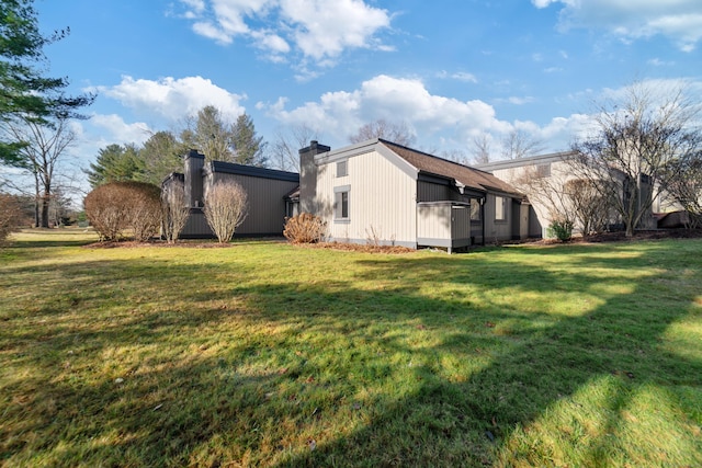 view of side of property with a lawn