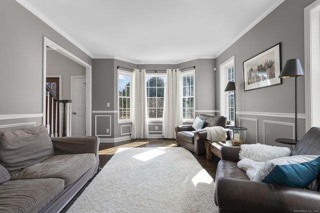 living room featuring ornamental molding, stairway, and wood finished floors