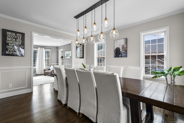 dining space featuring dark wood-style floors and ornamental molding